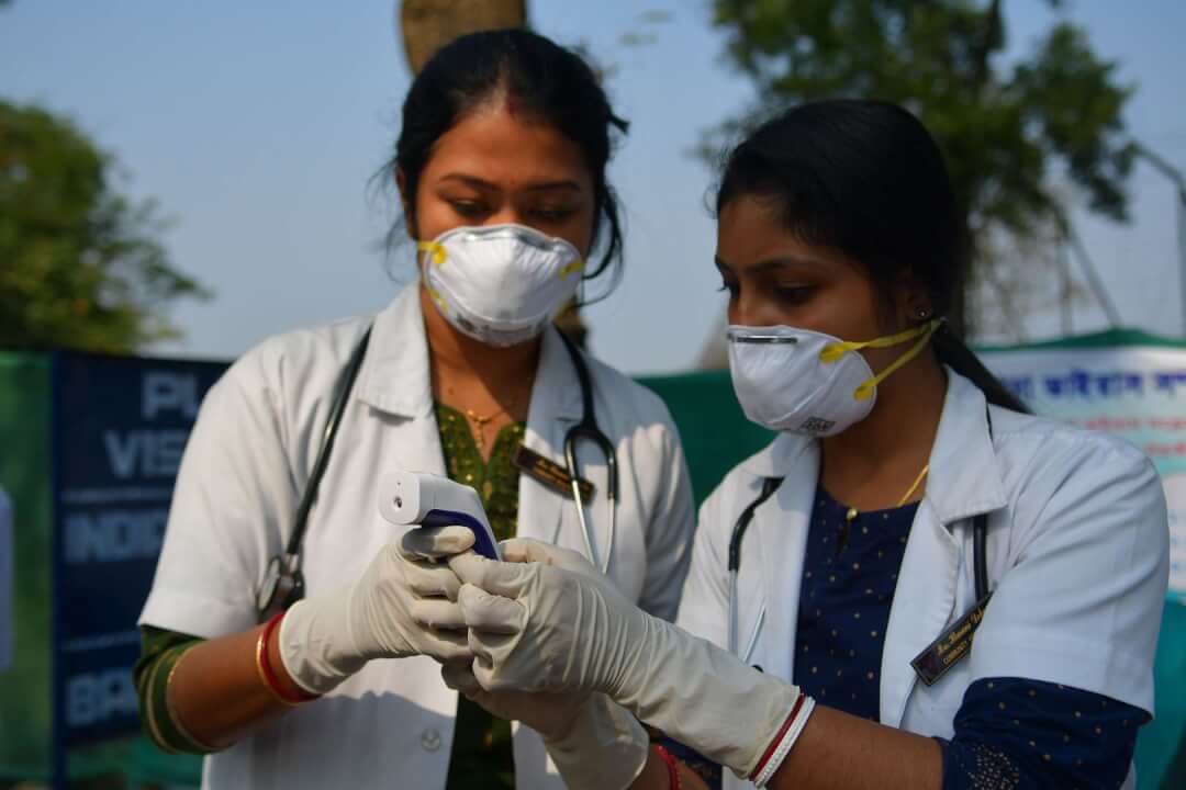 Doctors and health workers, are checking the body temperature of the people